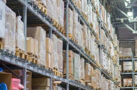 Rows of shelves with boxes in modern warehouse Stock Photos