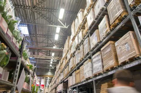 Rows of shelves with boxes in modern warehouse Stock-Fotos