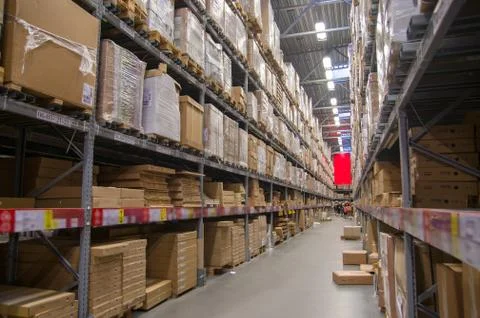 Rows of shelves with boxes in modern warehouse Foto stock