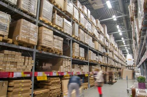 Rows of shelves with boxes in modern warehouse Stock Photos