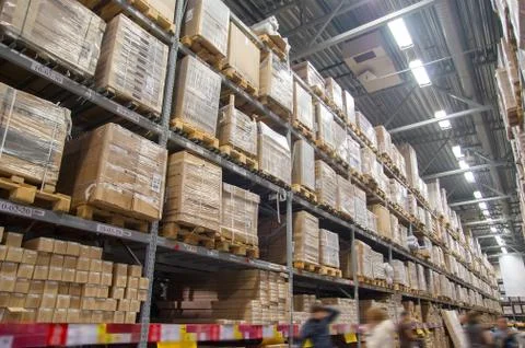 Rows of shelves with boxes in modern warehouse Stock Photos