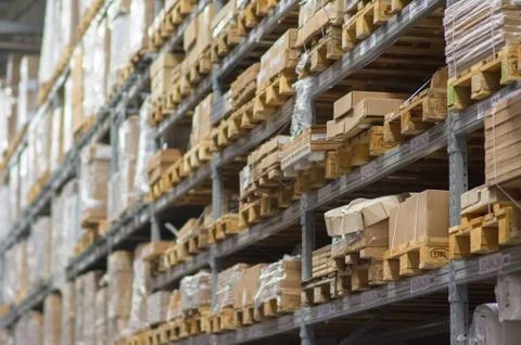 Rows of shelves with boxes in modern warehouse Stock Photos