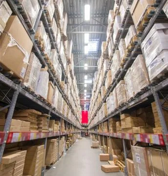 Rows of shelves with boxes in modern warehouse Stock Photos