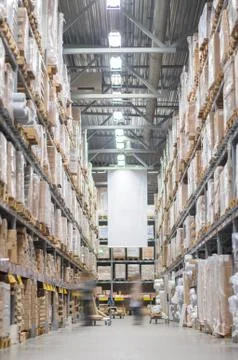 Rows of shelves with boxes in modern warehouse Stock Photos