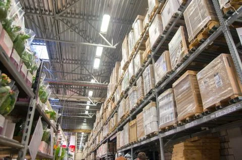 Rows of shelves with boxes in modern warehouse Stock Photos