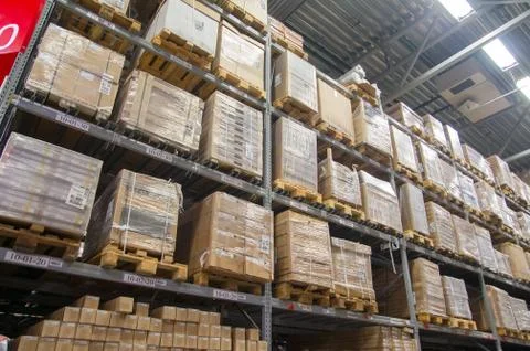 Rows of shelves with boxes in modern warehouse Foto stock