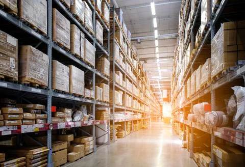 Rows of shelves with boxes in modern warehouse Stock Photos
