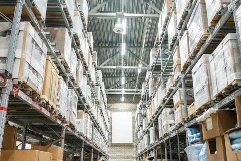 Rows of shelves with boxes in modern warehouse Foto stock