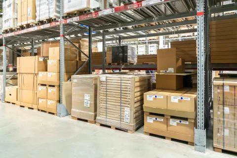 Rows of shelves with boxes in modern warehouse Stock Photos