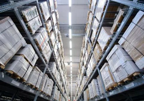 Rows of shelves with boxes in warehouse Stock Photos