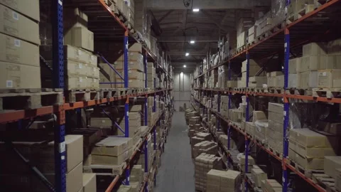 Rows of shelves inside an industrial warehouse with boxes. Stock Footage 252033035