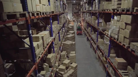 Rows of shelves inside an industrial warehouse with boxes. 스톡 동영상 252033036