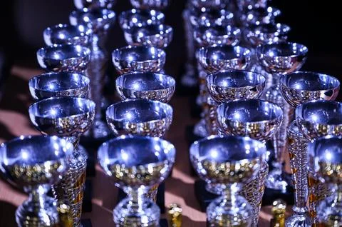 Rows of Silver Trophy Cups at Awards Ceremony Event Stock Photos