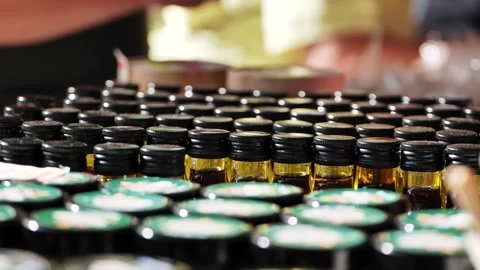 Rows of small amber bottles containing essential oil for aromatherapy and Stock Footage 348214759
