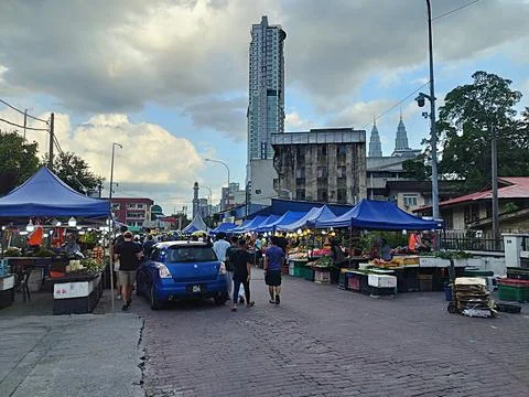 Rows of small roadside stalls with blue canvas roofs selling culinary goods Stock Photos