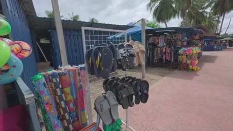 Rows of small shops at Pantai Teluk Kemang offer souvenirs and beach essentials. Stock Footage 308456253