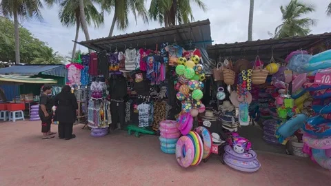 Rows of small shops at Pantai Teluk Kemang offer souvenirs and beach essentials. Stock Footage 308456314