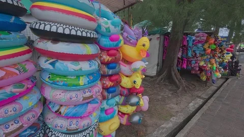Rows of small shops at Pantai Teluk Kemang offer souvenirs and beach essentials. Stock Footage 308456328