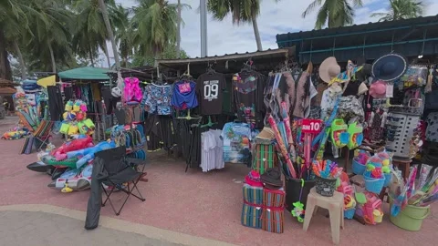Rows of small shops at Pantai Teluk Kemang offer souvenirs and beach essentials. Stock Footage 308456461