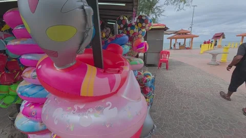 Rows of small shops at Pantai Teluk Kemang offer souvenirs and beach essentials. Stock Footage 308456506