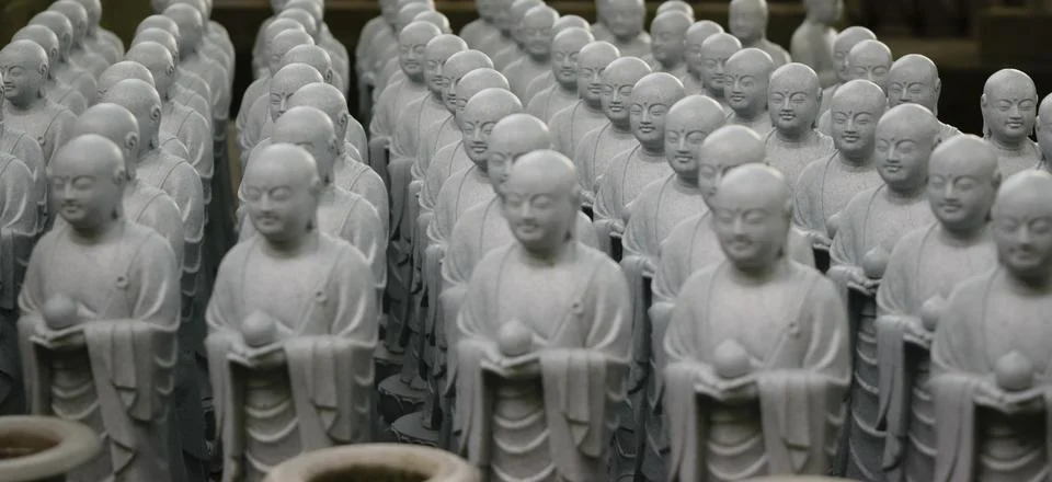 Rows of small stone Buddha statues Stock Photos