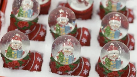 Rows of snow globes with snowman figurines closeup of boxed display, shopper Stock-Footage 320236921