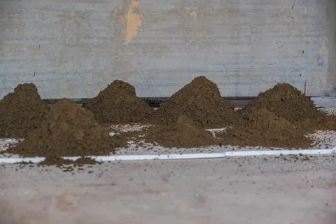 Rows of Soil Piles with White Pipe in Industrial Setting Stock-Fotos