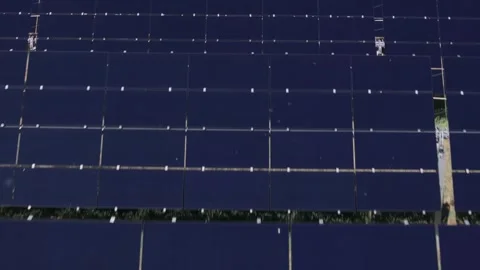 Rows of solar panels arranged in a grid pattern viewed from above under a Stock Footage 286845984