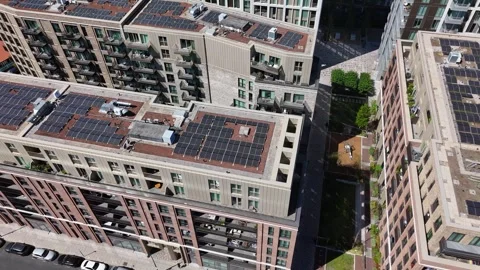 Rows of solar panels cover the roofs of a new build residential development Video stock 343467491