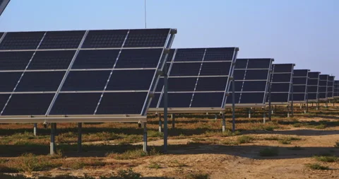 Rows of solar panels in farmland capturing clean renewable energy onsite Stock-Footage 302397757