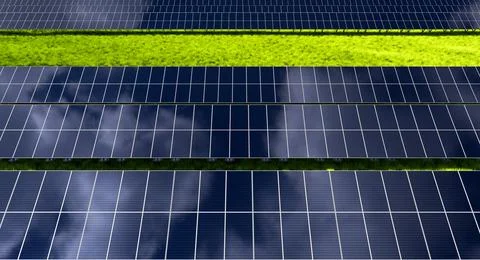 Rows of solar panels in a field on a background of green grass. Ground powe.. Stock Photos