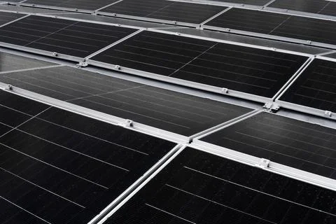 Rows of solar panels installed on a flat membrane roof Stock Photos