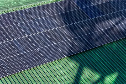 Rows of solar panels located on roofing covered with patinated copper Stock Photos