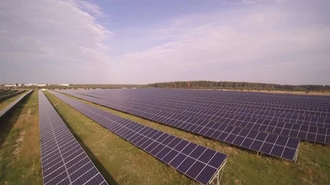 Rows of solar panels produce clean energy at substation Stock Footage 169854926