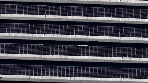 Rows of solar panels on a rooftop, generating clean energy from sunlight Stock Photos