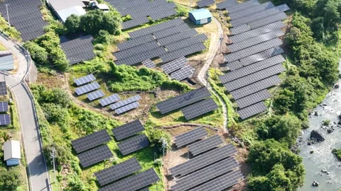 Rows of solar panels stretch across green hillsides Stock Footage 340898118