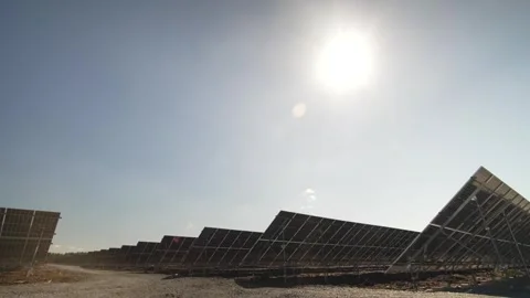 Rows of Solar Panels Under Bright Skies with Diffused Clouds Fading to Sunshine Video stock 294528778