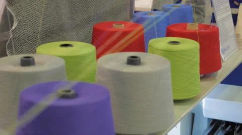 Rows spools of thread of different colors in the industrial sewing machine Stock Footage 68369485
