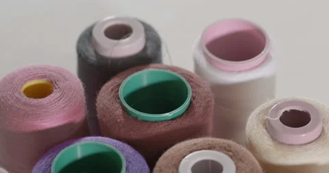 Rows spools of thread of different colors in the industrial sewing machine Stock Footage 131136005