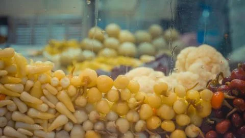 Rows of stack white fruits inside a glass container Stock Photos