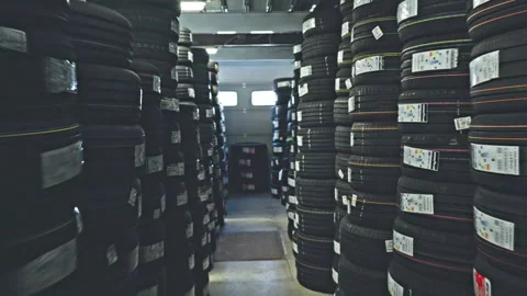 Rows of stacked car tires in an auto workshop warehouse Stock Footage 318781252