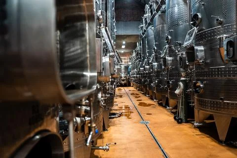 Rows of stainless steel wine fermentation tanks in modern winery cellar Stock Photos