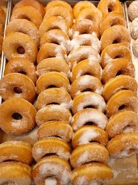 Rows of Sugar-Coated Ring Doughnuts at Thai Bakery Stock Photos