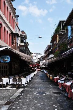 Rows of tables are covered with white tablecloths. Stock Photos
