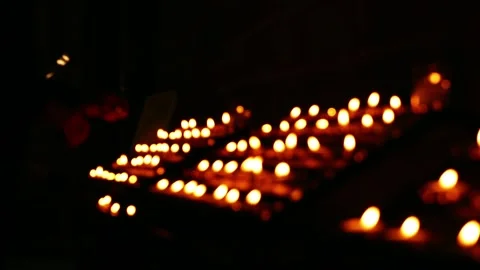 Rows of tea light candles bokeh burning in a church Stock Footage 237916537