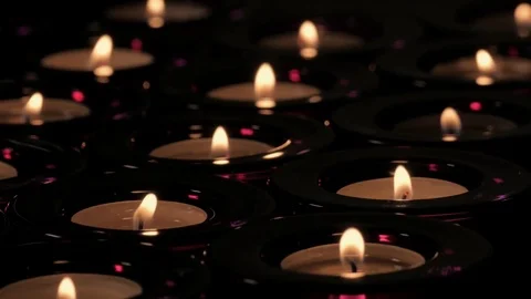 Rows of tealight candles with flickering flames extinguished and blown out Stock Footage 73952979