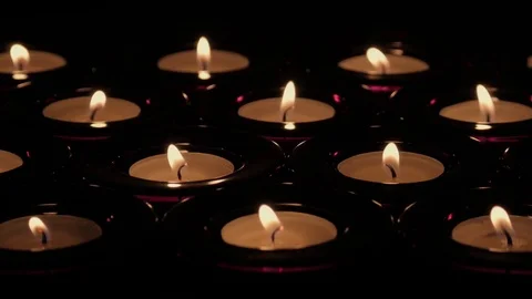 Rows of tealight candles with flickering flames Stock Footage 73955744