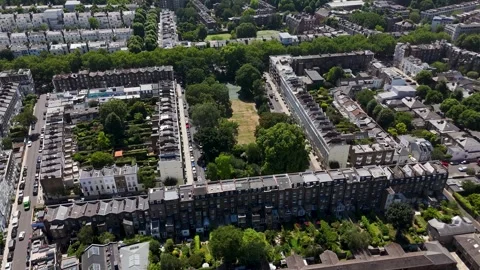 Rows of terraced houses form a rectangle around a private communal garden Stock Footage 343473568