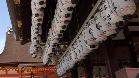 Rows of Traditional Paper Lanterns Hanging from a Japanese Shrine Roof Stock Footage 337689787