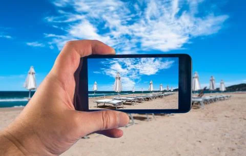 Rows of umbrellas and deck chairs on the beach Stock Photos